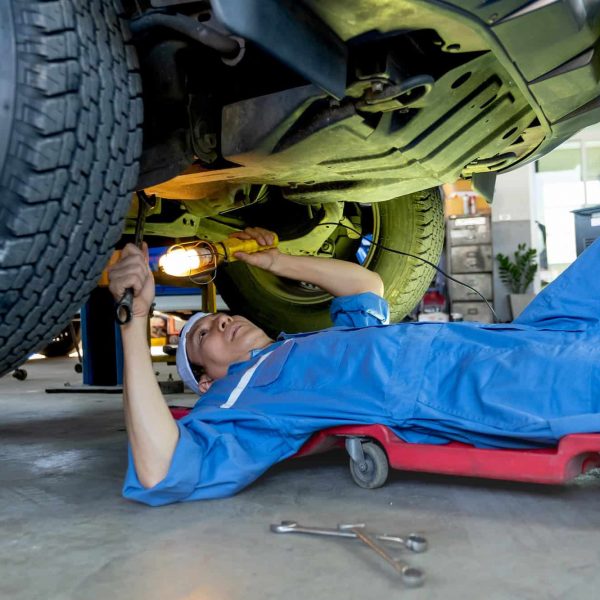 technician-or-garage-worker-lie-down-under-the-car-and-use-lantern-to-guide-for-fix-the-problem.jpg