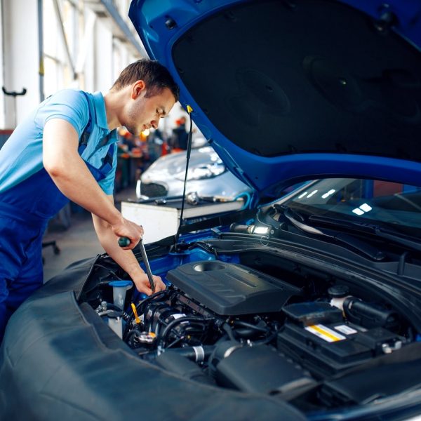 worker-in-uniform-checks-engine-car-service-2021-08-27-11-44-45-utc-min.jpg